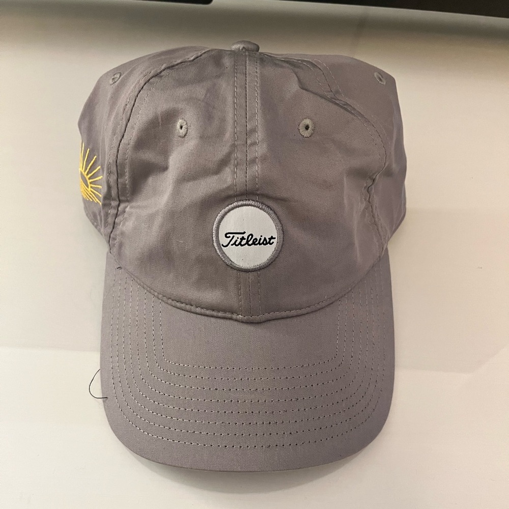 Brand new Titleist golf hat. Velcro back with sun logo